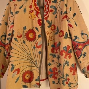 This jacket is lined with zipper in front . Great to wear dressy or with jeans.